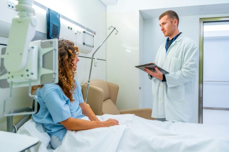 Doctor talking and visiting a patient on the hospital bed